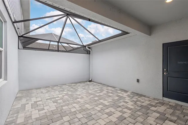 an aerial view of a house with a big yard