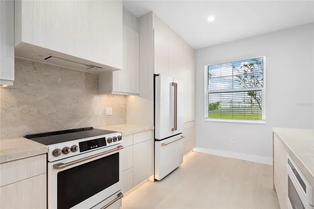 a kitchen with a refrigerator stove and microwave