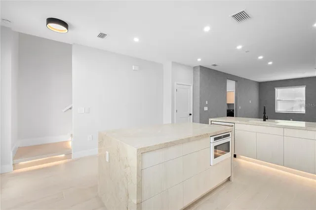 a kitchen with white cabinets