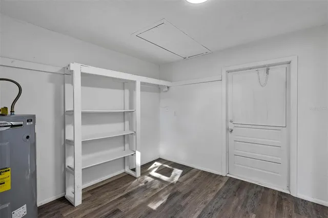 a view of an empty room and wooden floor