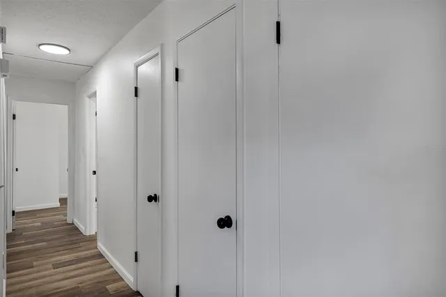 a view of a hallway with wooden floor