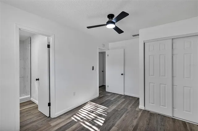 a view of empty room with wooden floor