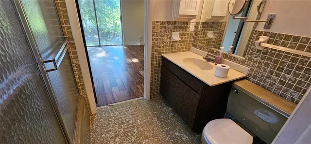 a bathroom with a sink a toilet a mirror and vanity