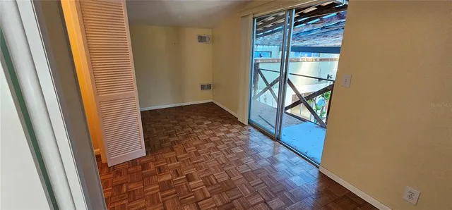 a view of a forest with trees in the background
