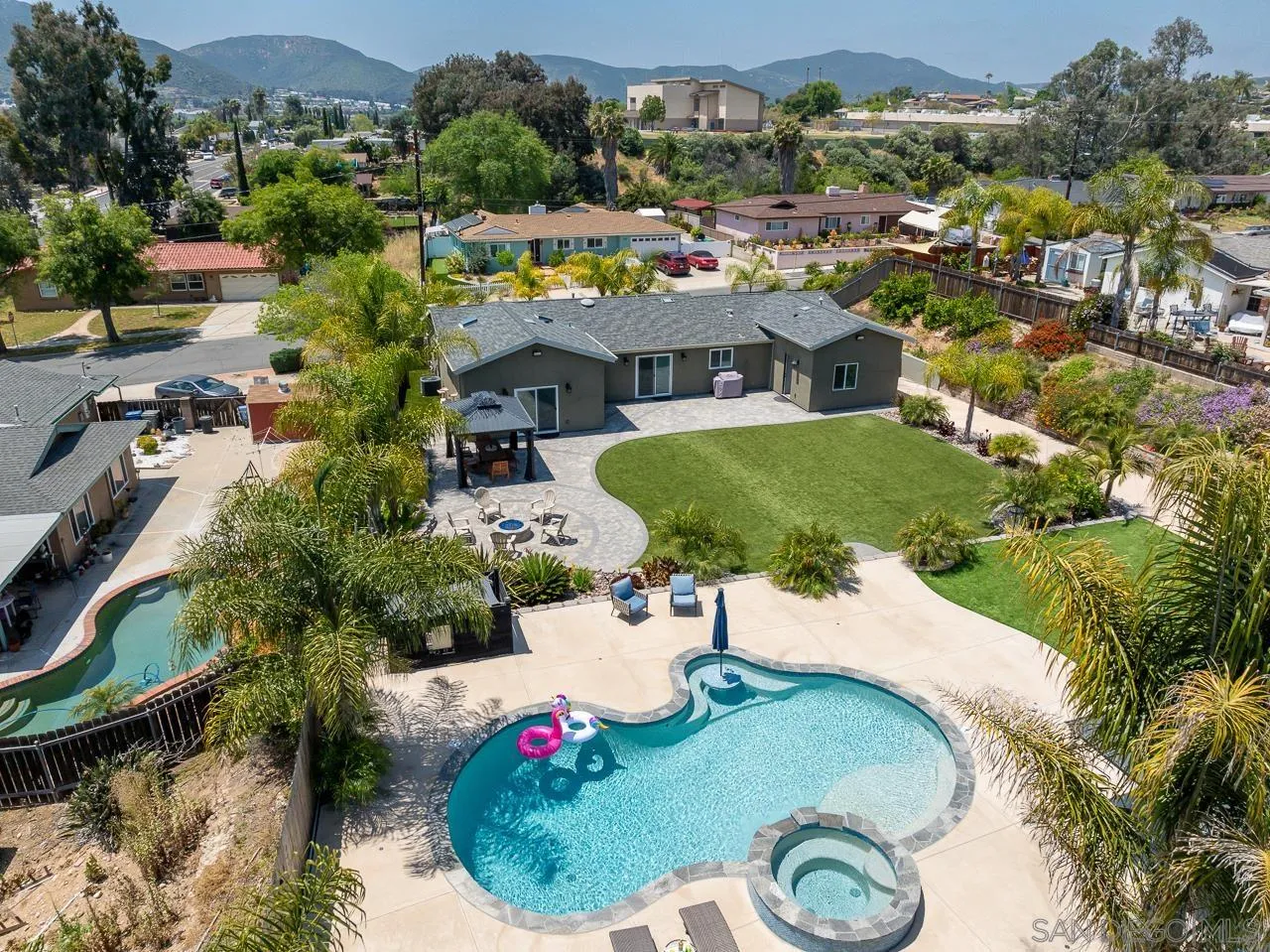 an aerial view of a house with yard swimming pool and outdoor seating