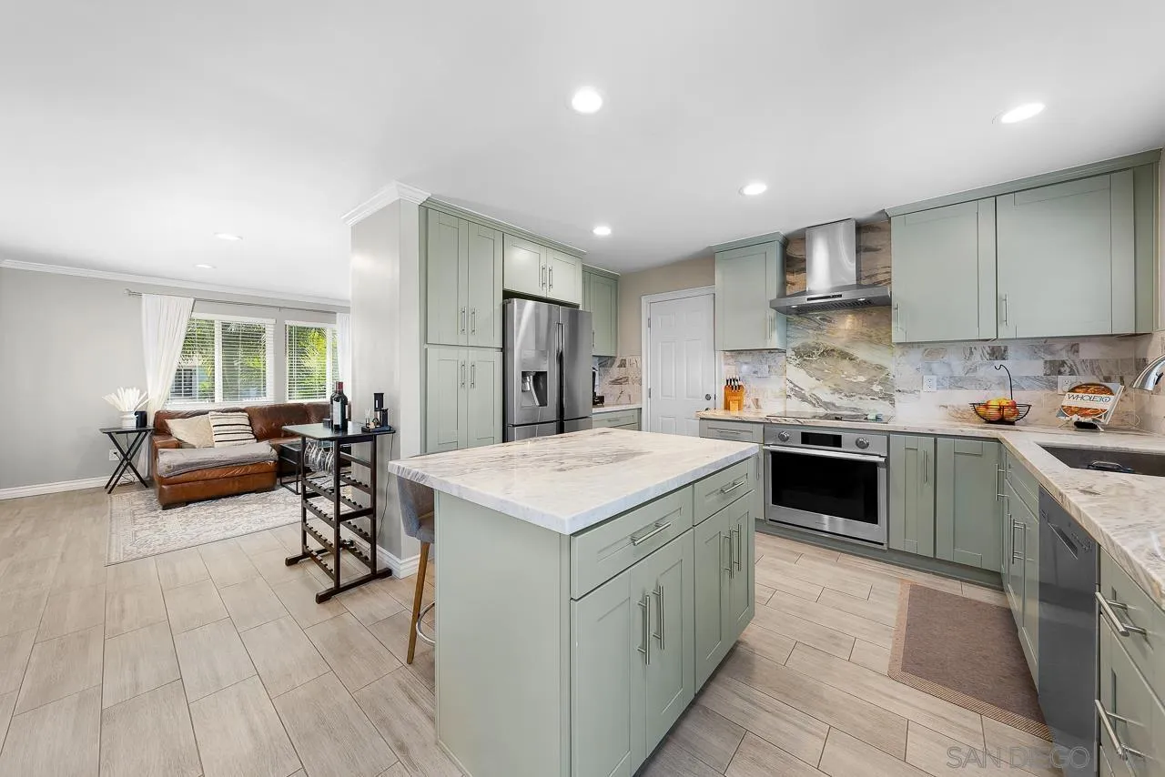 9311 Oakbourne Road Santee, CA 92071 - Photo 14 of 64 a kitchen with a sink a counter top space and stainless steel appliances