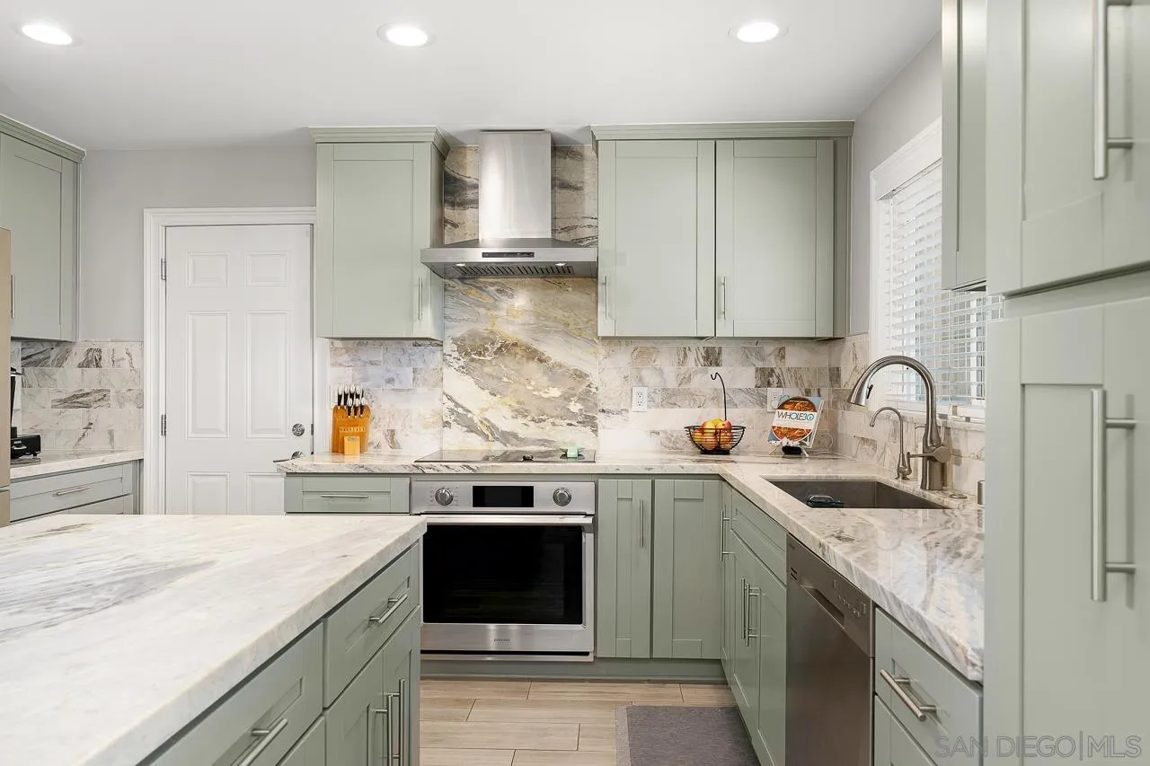 9311 Oakbourne Road Santee, CA 92071 - Photo 15 of 64 a kitchen with stainless steel appliances granite countertop a sink stove and cabinets