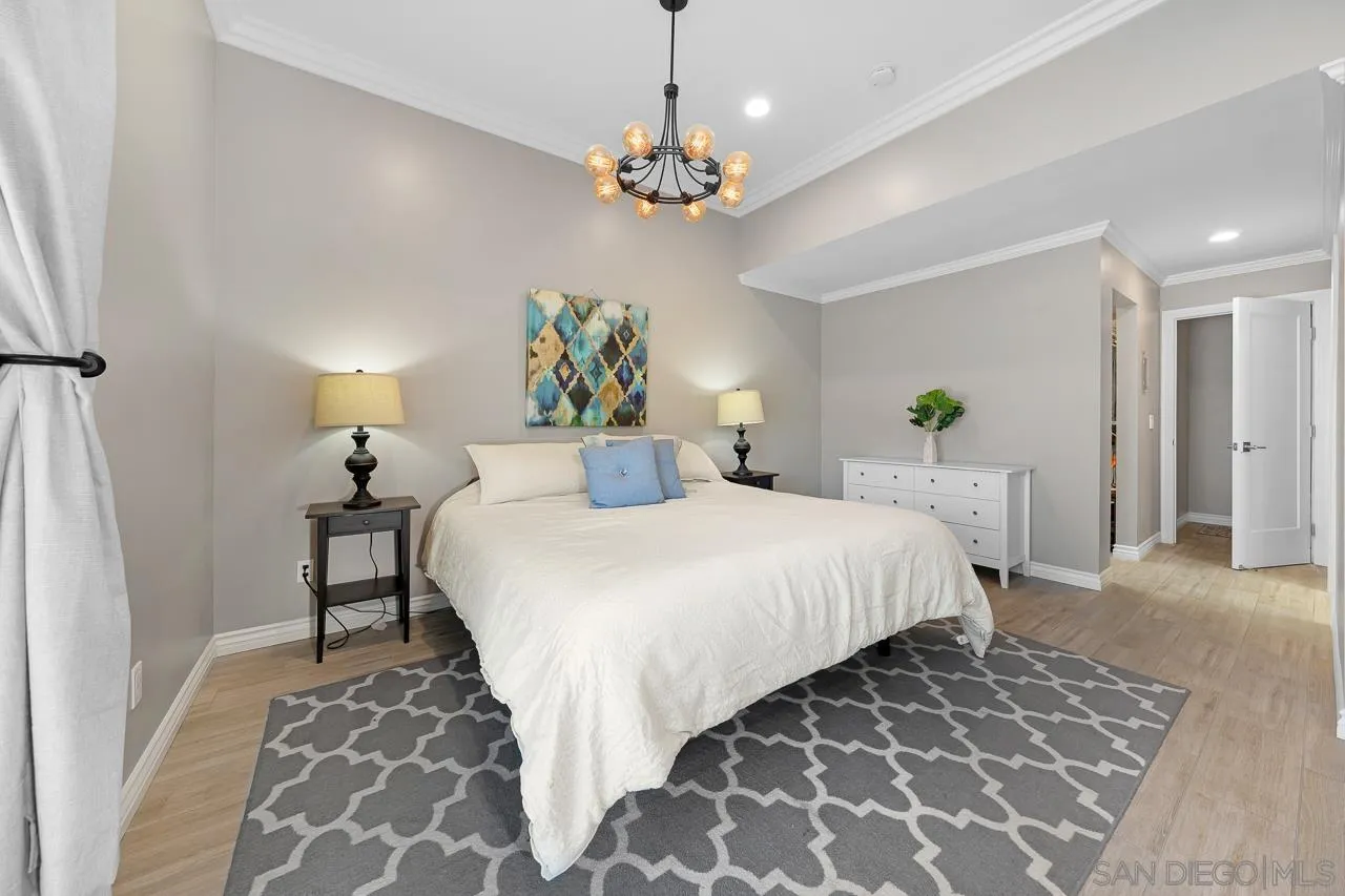 9311 Oakbourne Road Santee, CA 92071 - Photo 17 of 64 a bedroom with a bed and a chandelier