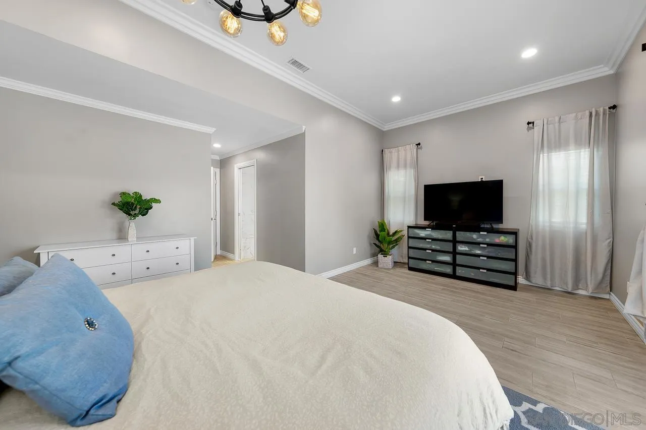 9311 Oakbourne Road Santee, CA 92071 - Photo 18 of 64 a spacious bedroom with a bed and a flat screen tv