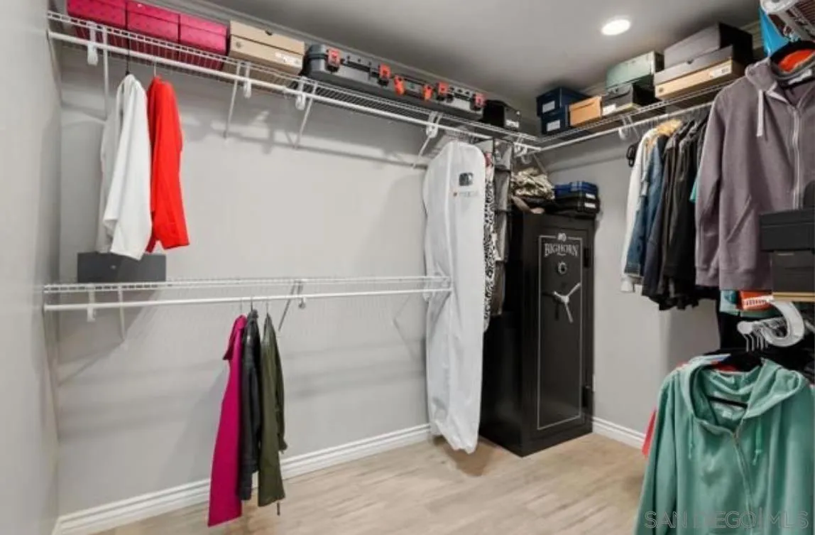 9311 Oakbourne Road Santee, CA 92071 - Photo 19 of 64 a view of walk in closet with clothes and shoes