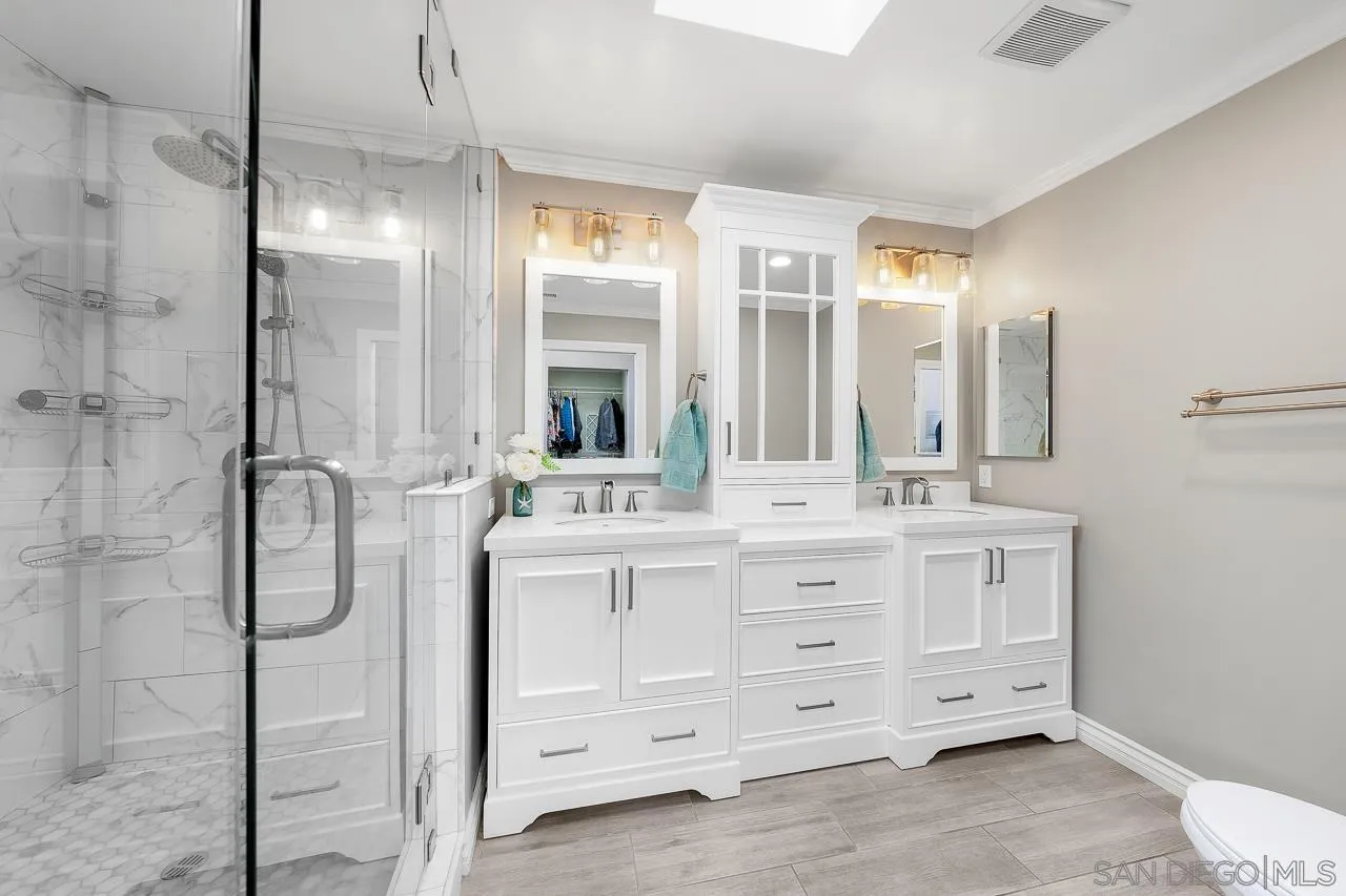 9311 Oakbourne Road Santee, CA 92071 - Photo 20 of 64 a bathroom with a double vanity sink and mirror