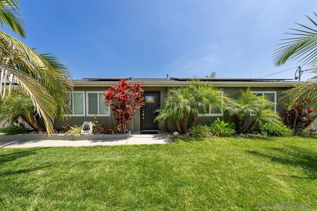9311 Oakbourne Road Santee, CA 92071 - Photo 3 of 64 a view of a patio with table and chairs under an umbrella