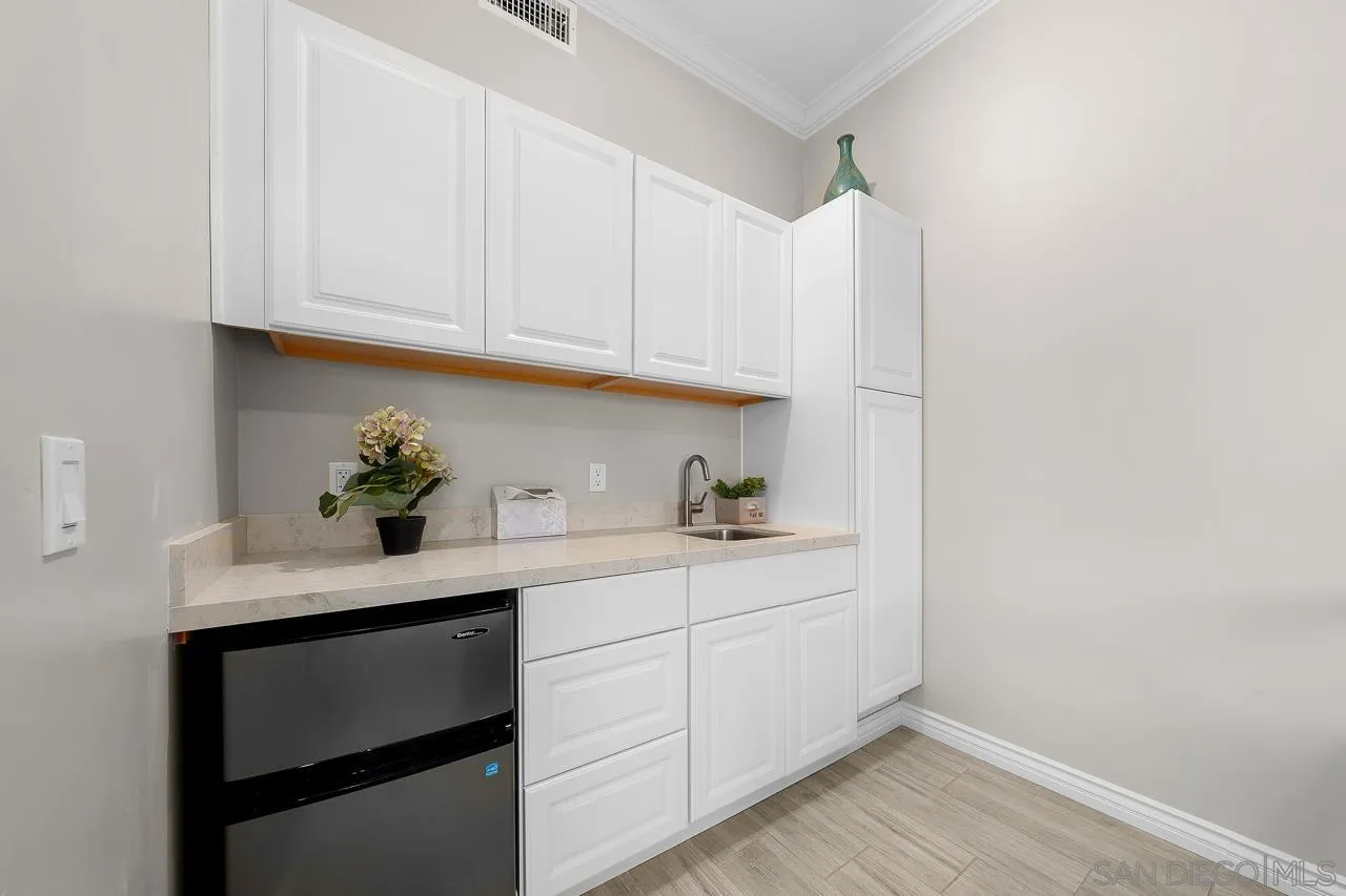 9311 Oakbourne Road Santee, CA 92071 - Photo 32 of 64 a kitchen with granite countertop white cabinets and white appliances