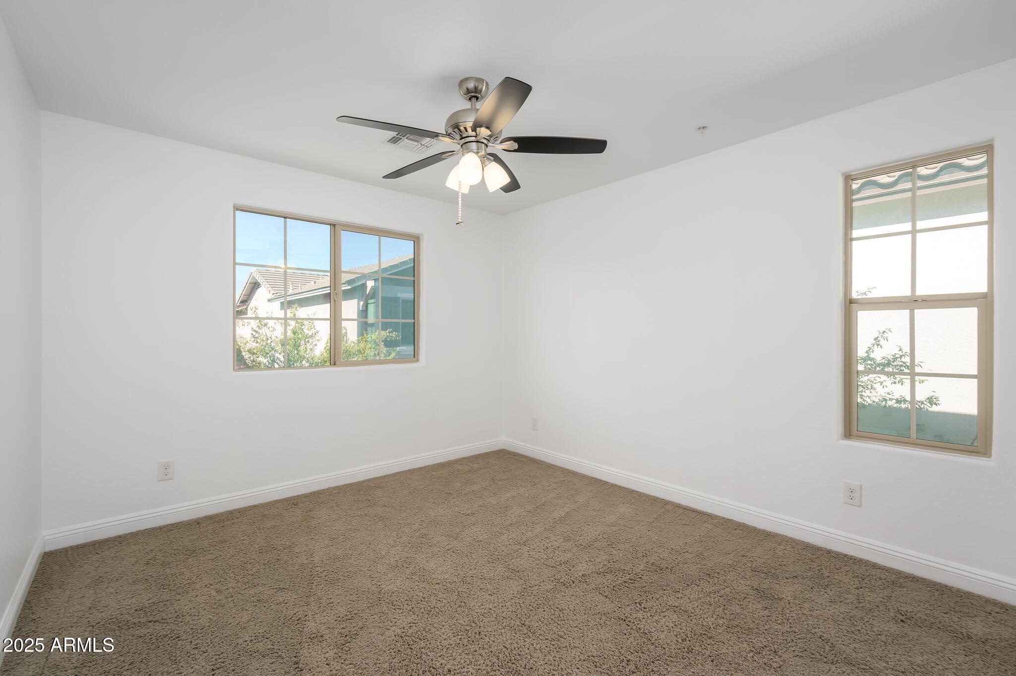 20563 West White Rock Road Buckeye, AZ 85396 - Photo 13 of 17 an empty room with windows and fan
