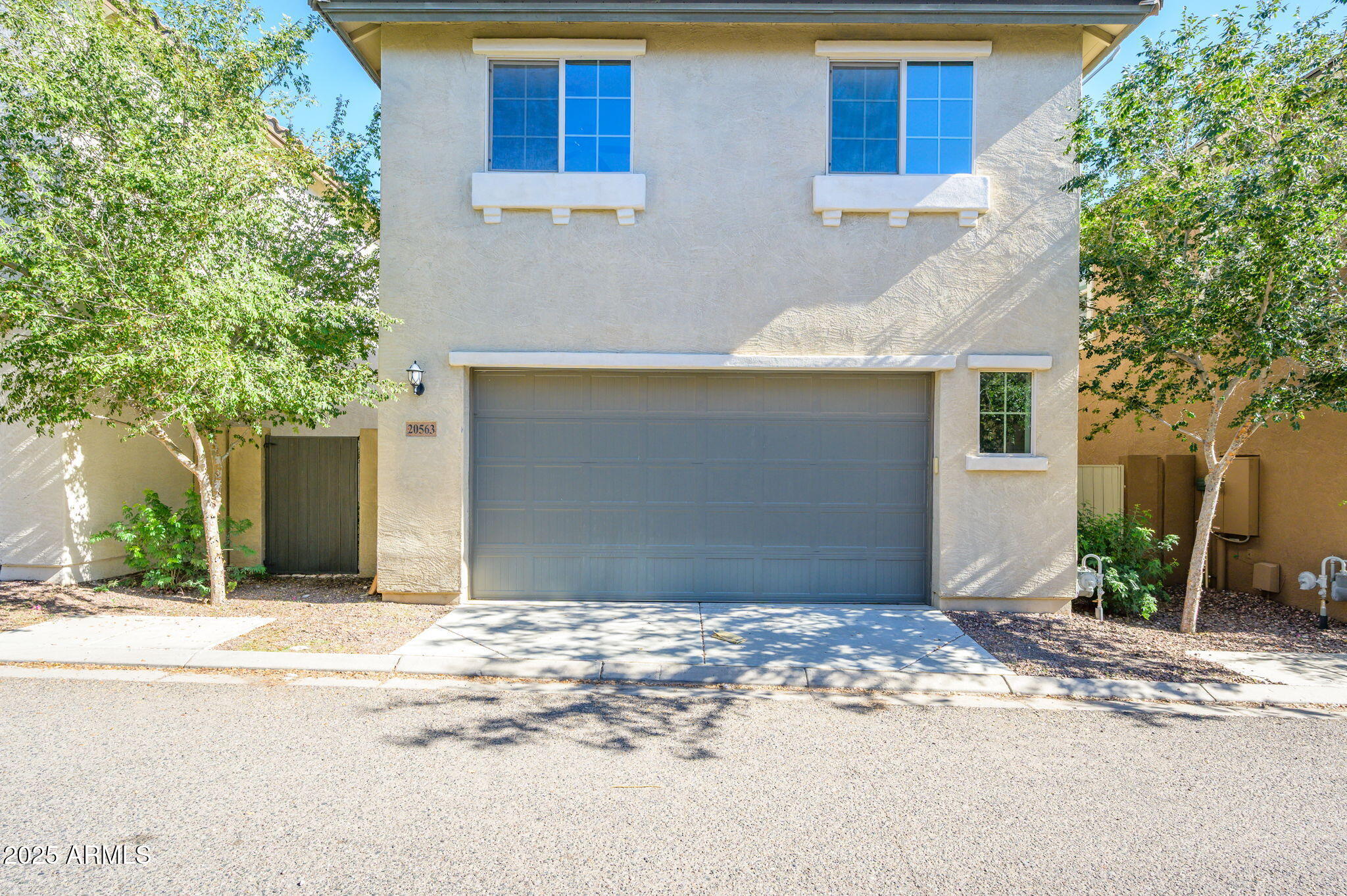 20563 West White Rock Road Buckeye, AZ 85396 - Photo 2 of 17 a front view of a house with a yard and garage