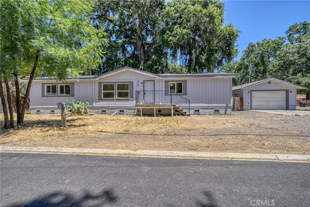 an aerial view of a house with yard and sitting area