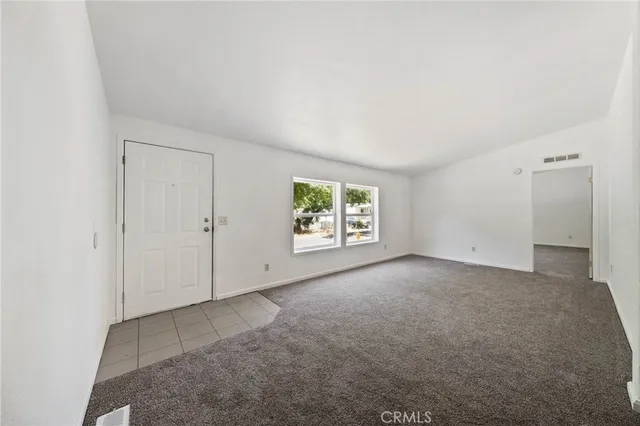 an empty room with an empty space and windows