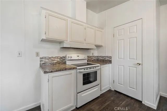 a kitchen with cabinets wooden floor and a sink
