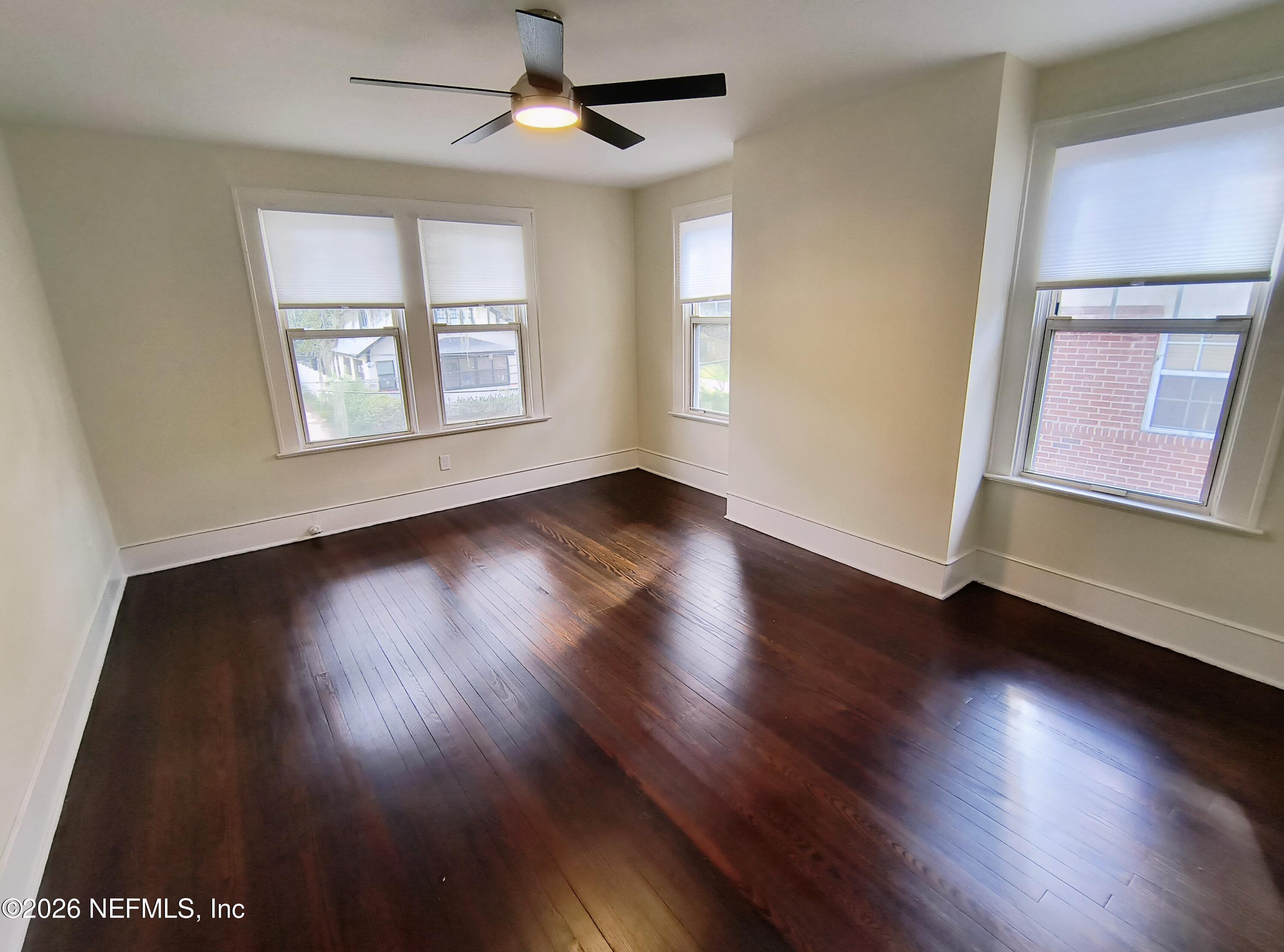 3577 Valencia Road, Unit 1 Jacksonville, FL 32205 - Photo 11 of 17 a view of an empty room with wooden floor and a window