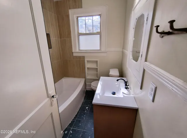 a bathroom with sink and bathtub