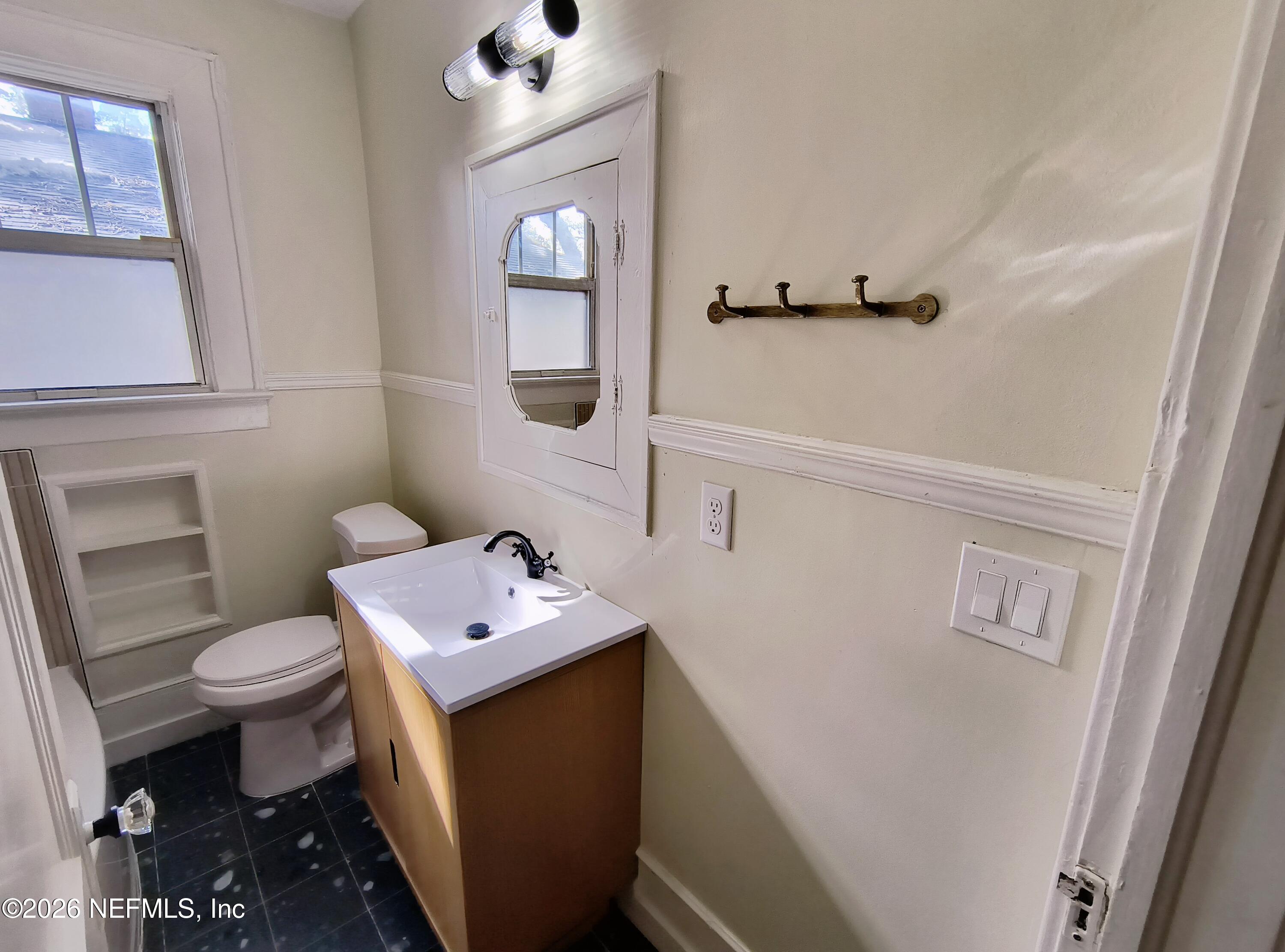 3577 Valencia Road, Unit 1 Jacksonville, FL 32205 - Photo 16 of 17 a bathroom with a sink toilet and vanity