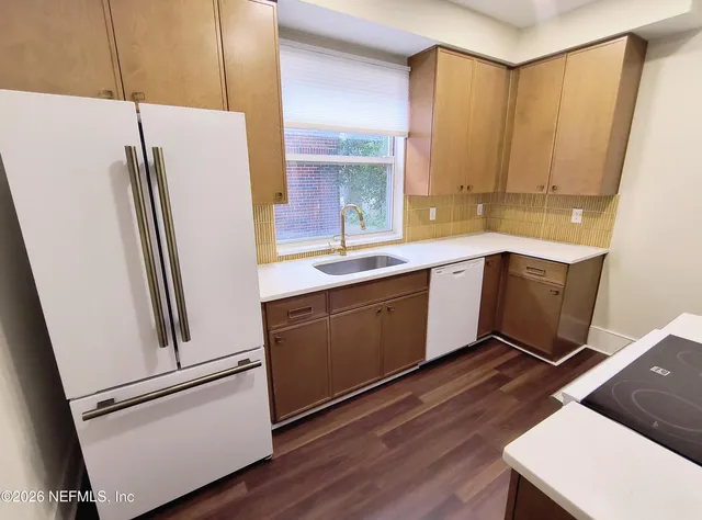 a kitchen with stainless steel appliances a refrigerator and a sink