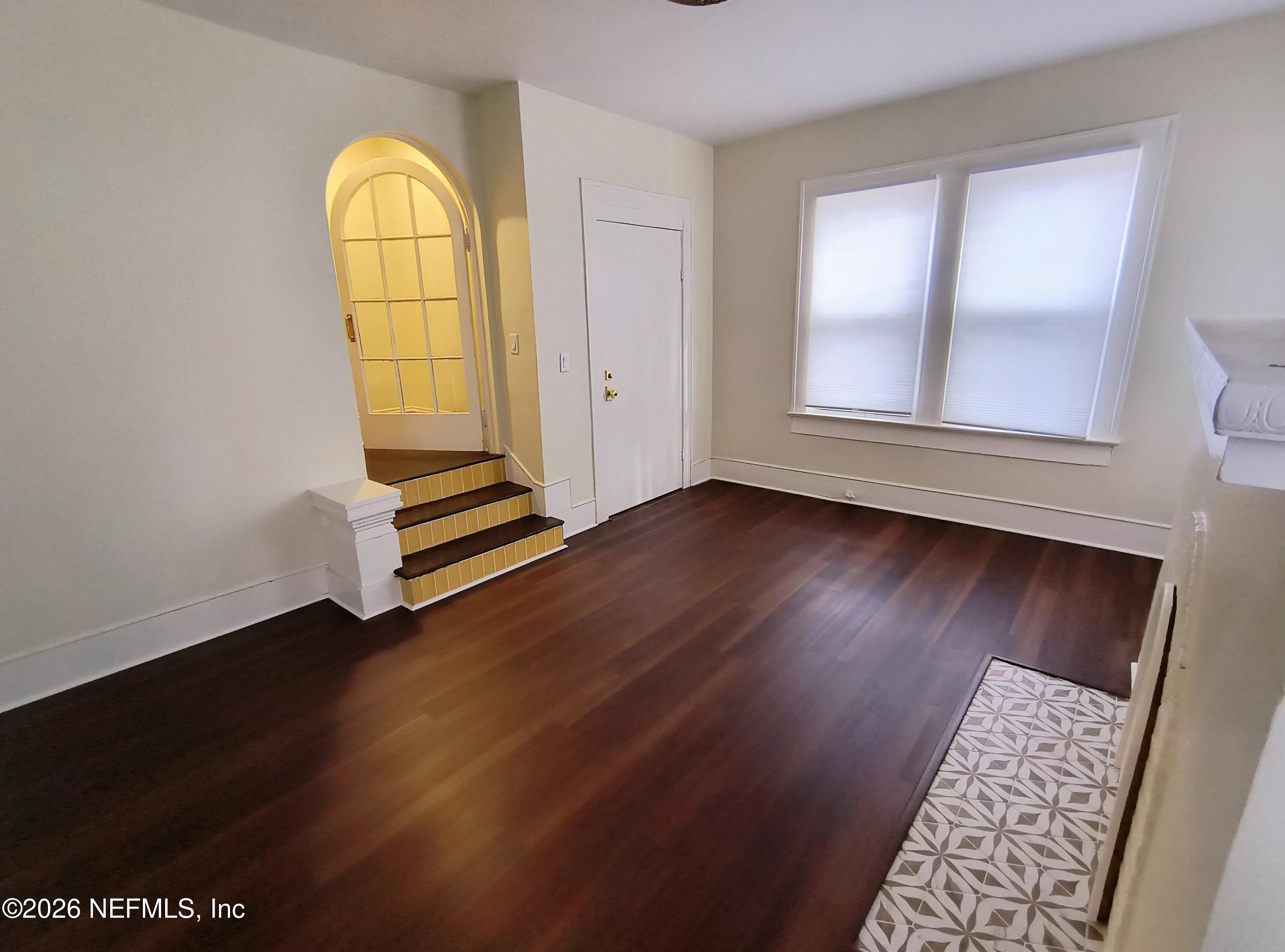 3577 Valencia Road, Unit 1 Jacksonville, FL 32205 - Photo 6 of 17 an empty room with wooden floor and windows