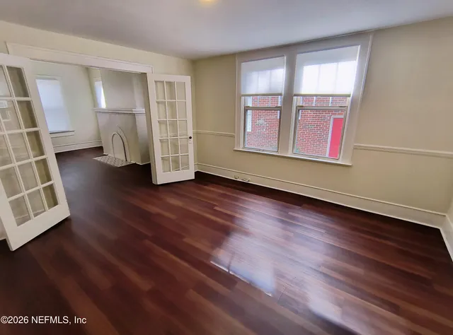 wooden floor in an empty room with a window