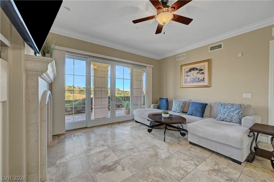 10 Strada Bella Vista, Unit 101 Henderson, NV 89011 - Photo 11 of 64 Living room featuring ceiling fan, and crown molding