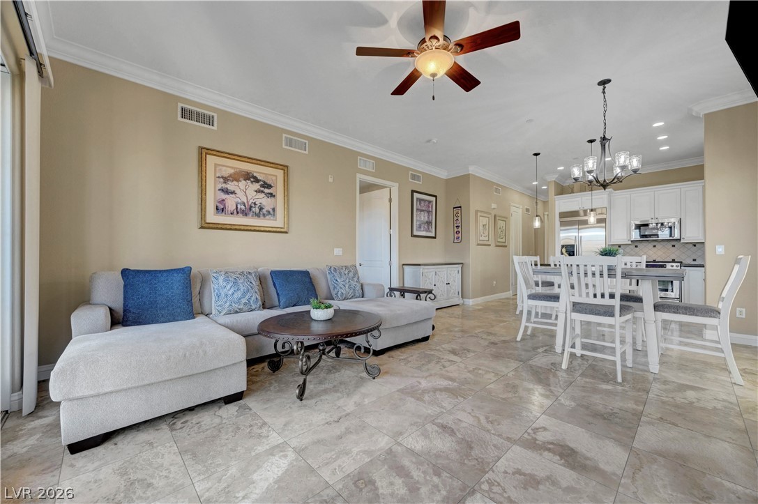 10 Strada Bella Vista, Unit 101 Henderson, NV 89011 - Photo 12 of 64 Living room with a ceiling fan, crown molding
.