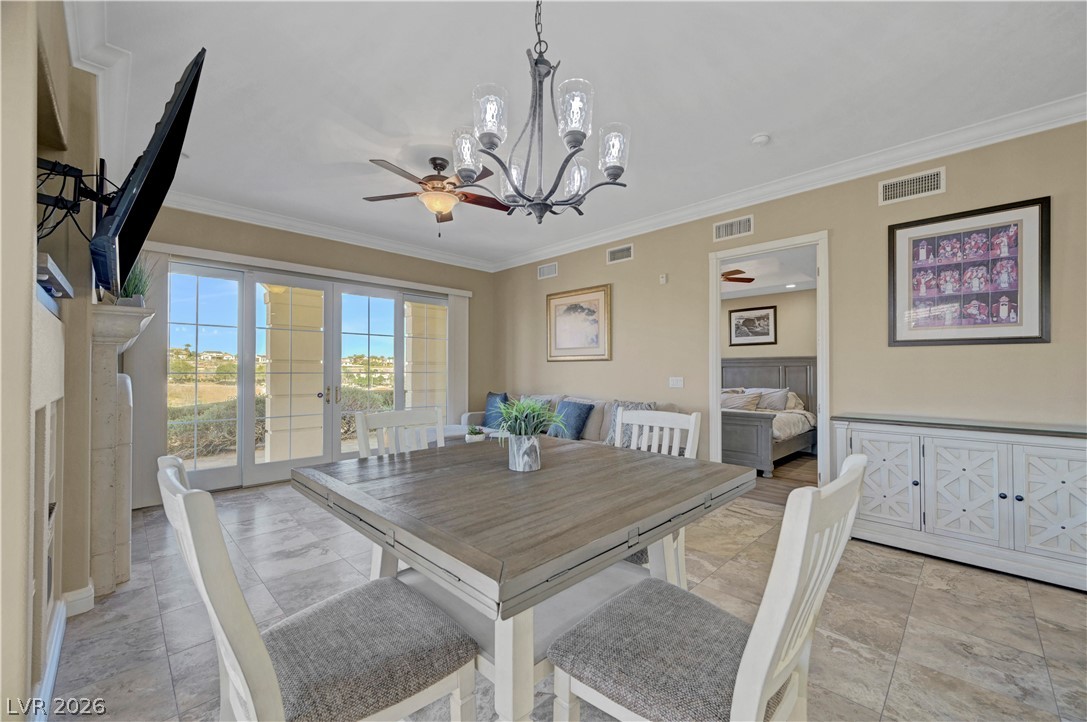 10 Strada Bella Vista, Unit 101 Henderson, NV 89011 - Photo 15 of 64 Dining space with a chandelier, crown molding.