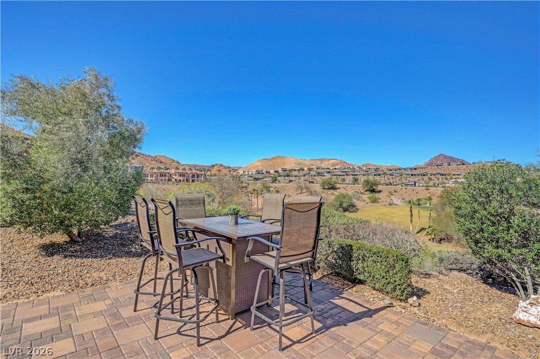 10 Strada Bella Vista, Unit 101 Henderson, NV 89011 - Photo 43 of 64 View of patio featuring outdoor dining area and a mountain view