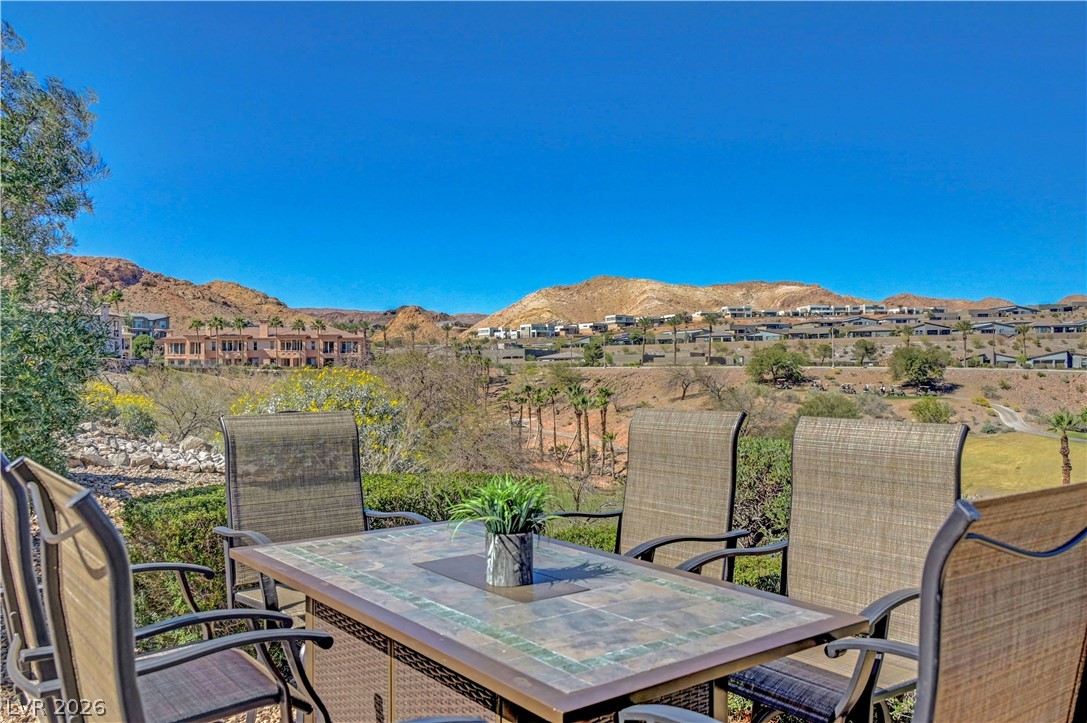 10 Strada Bella Vista, Unit 101 Henderson, NV 89011 - Photo 43 of 64 View of patio featuring outdoor dining space and a mountain view