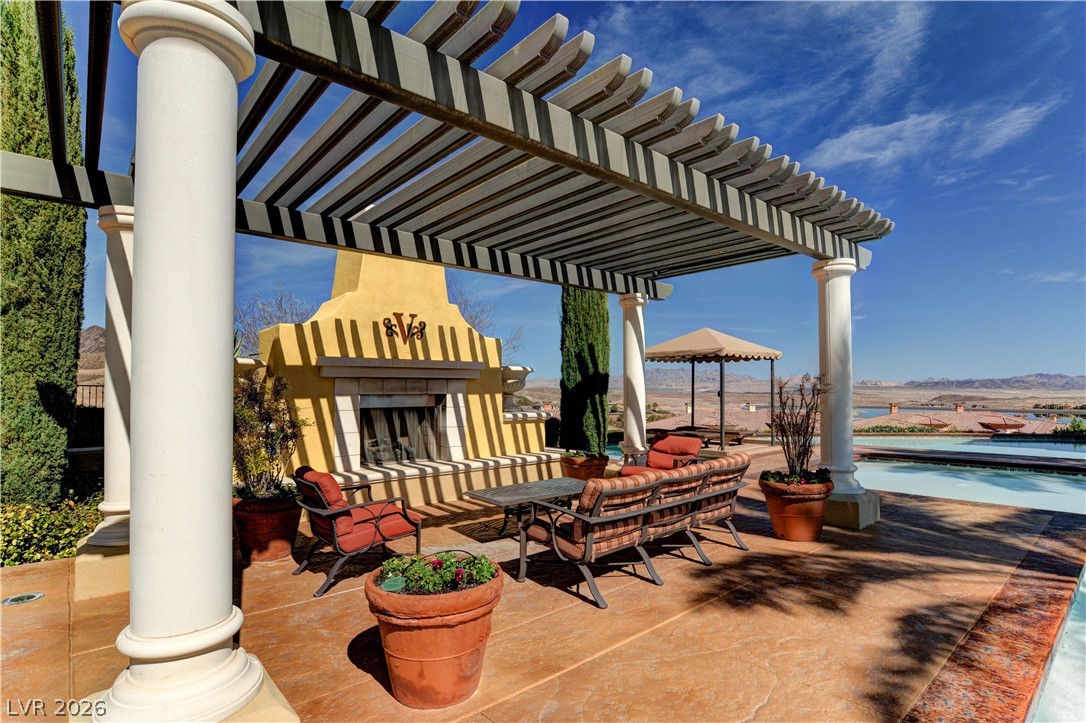 10 Strada Bella Vista, Unit 101 Henderson, NV 89011 - Photo 58 of 64 Patio / terrace featuring a pergola, an outdoor living space with a fireplace, and an outdoor pool
