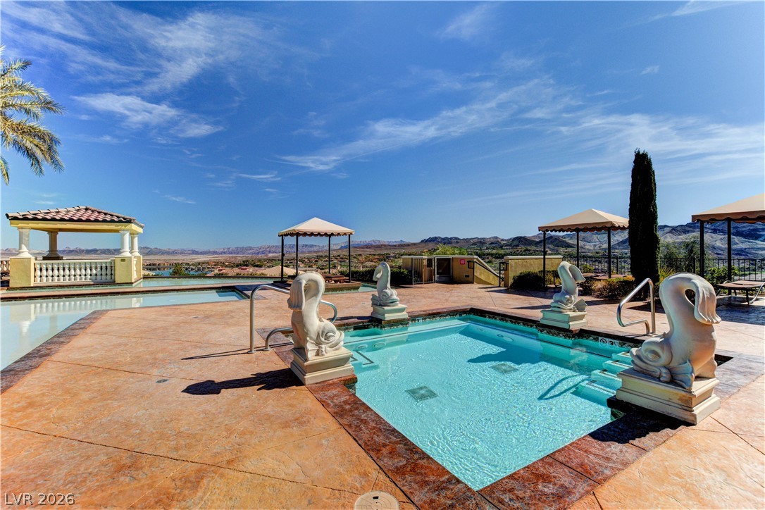 10 Strada Bella Vista, Unit 101 Henderson, NV 89011 - Photo 60 of 64 View of pool featuring a gazebo, patio surround, and a mountain view