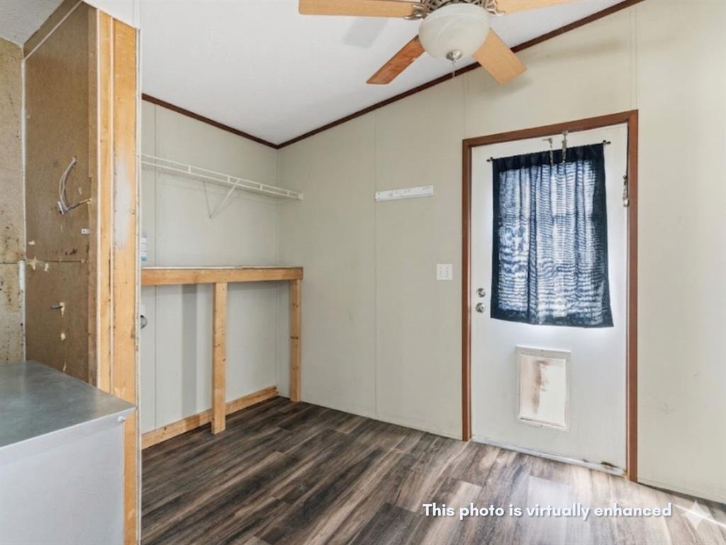 2722 Denver Road Sunset, TX 76270 - Photo 17 of 19 Utility space featuring wood-finish flooring, a white exterior door, and a built-in ceiling fan