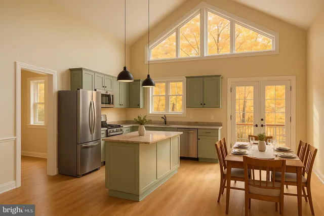 a kitchen with stainless steel appliances granite countertop a stove a refrigerator a sink a dining table and chairs with wooden floor