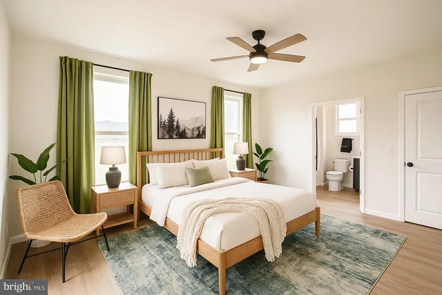 a bedroom with a bed a couch and a large window