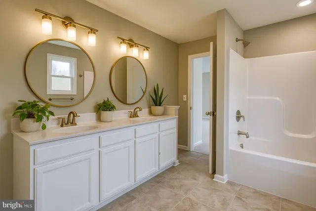 a bathroom with a double vanity sink and a mirror