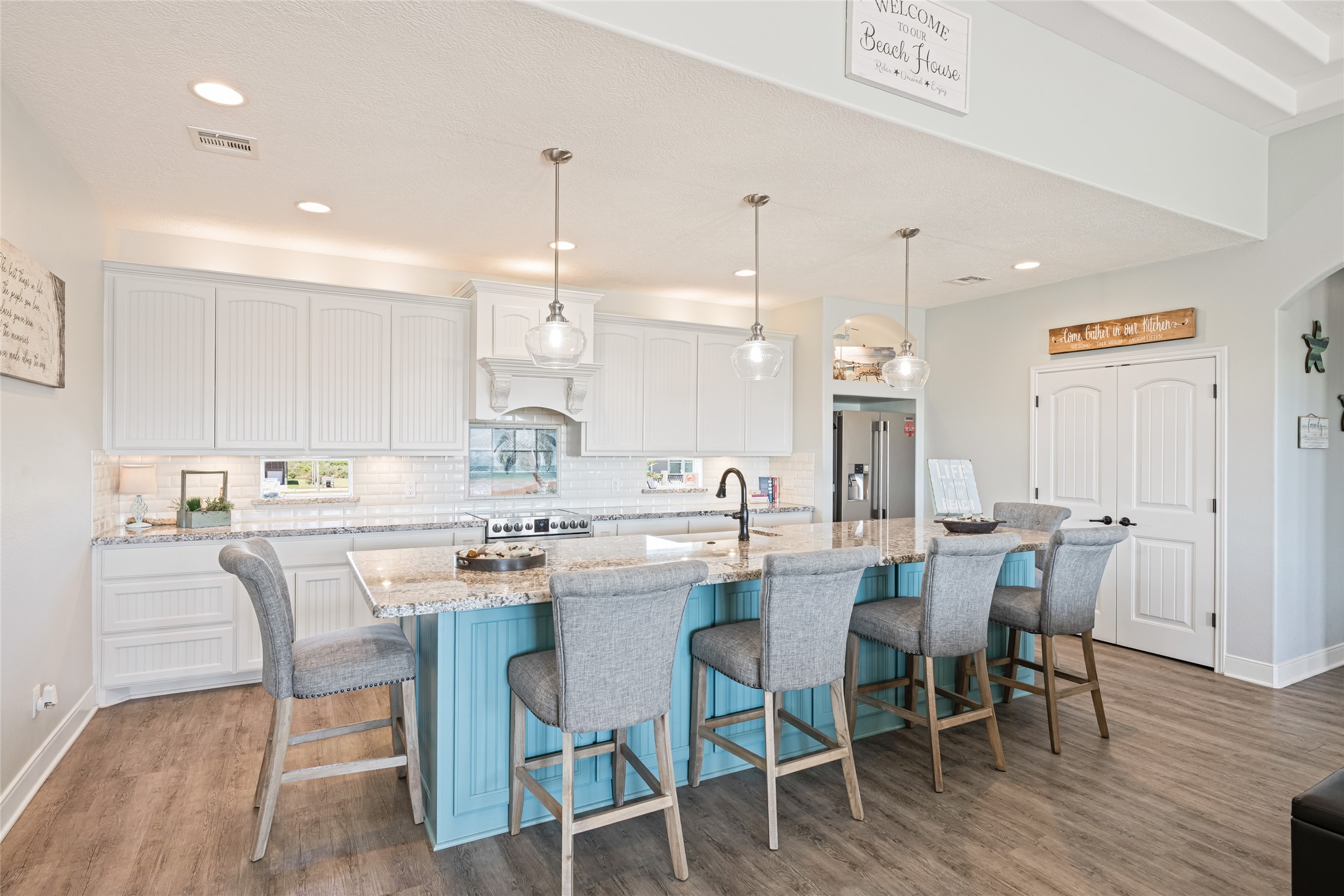 817 Boyt Road Crystal Beach, TX 77650 - Photo 21 of 49 a kitchen with a dining table chairs wooden floor and appliances