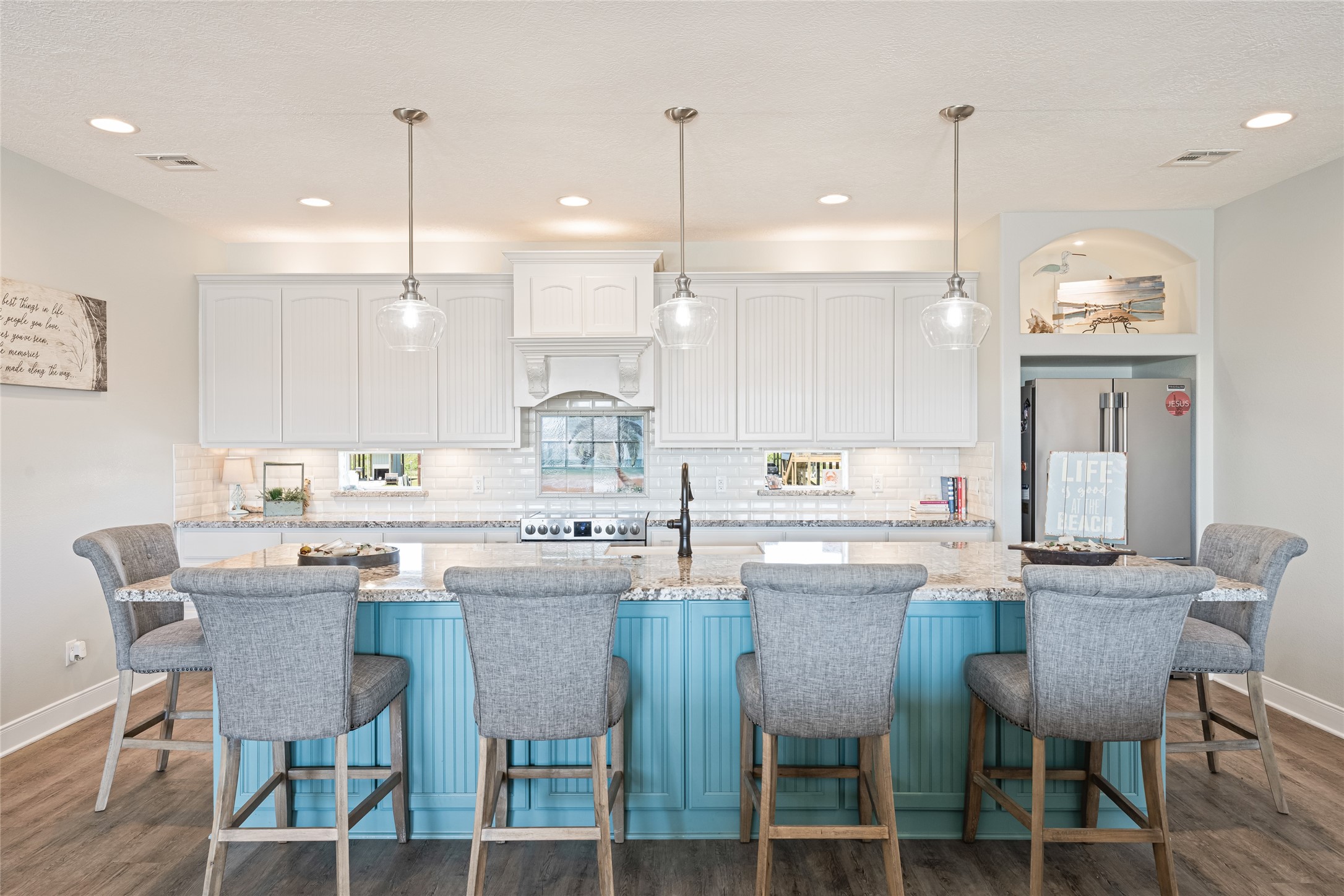 817 Boyt Road Crystal Beach, TX 77650 - Photo 22 of 49 a kitchen with kitchen island granite countertop a sink a stove a dining table and chairs