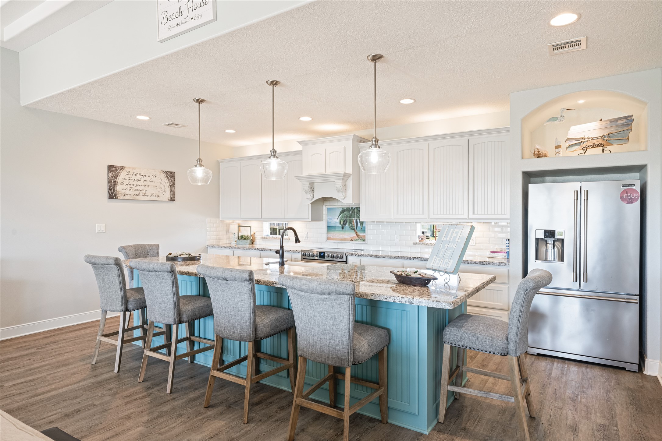 817 Boyt Road Crystal Beach, TX 77650 - Photo 23 of 49 a kitchen with a dining table chairs wooden floor and appliances