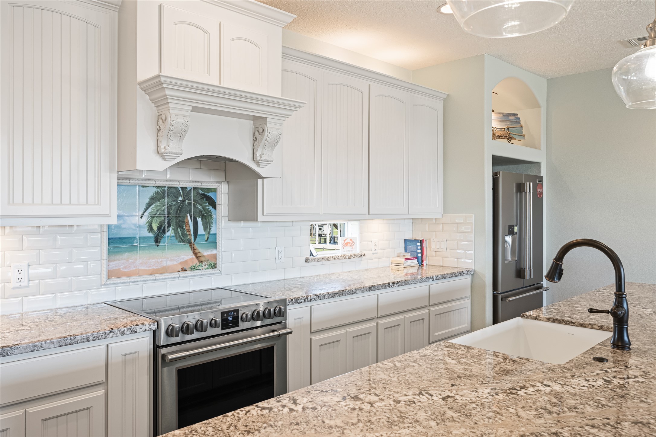 817 Boyt Road Crystal Beach, TX 77650 - Photo 24 of 49 a kitchen with a stove a sink and a refrigerator
