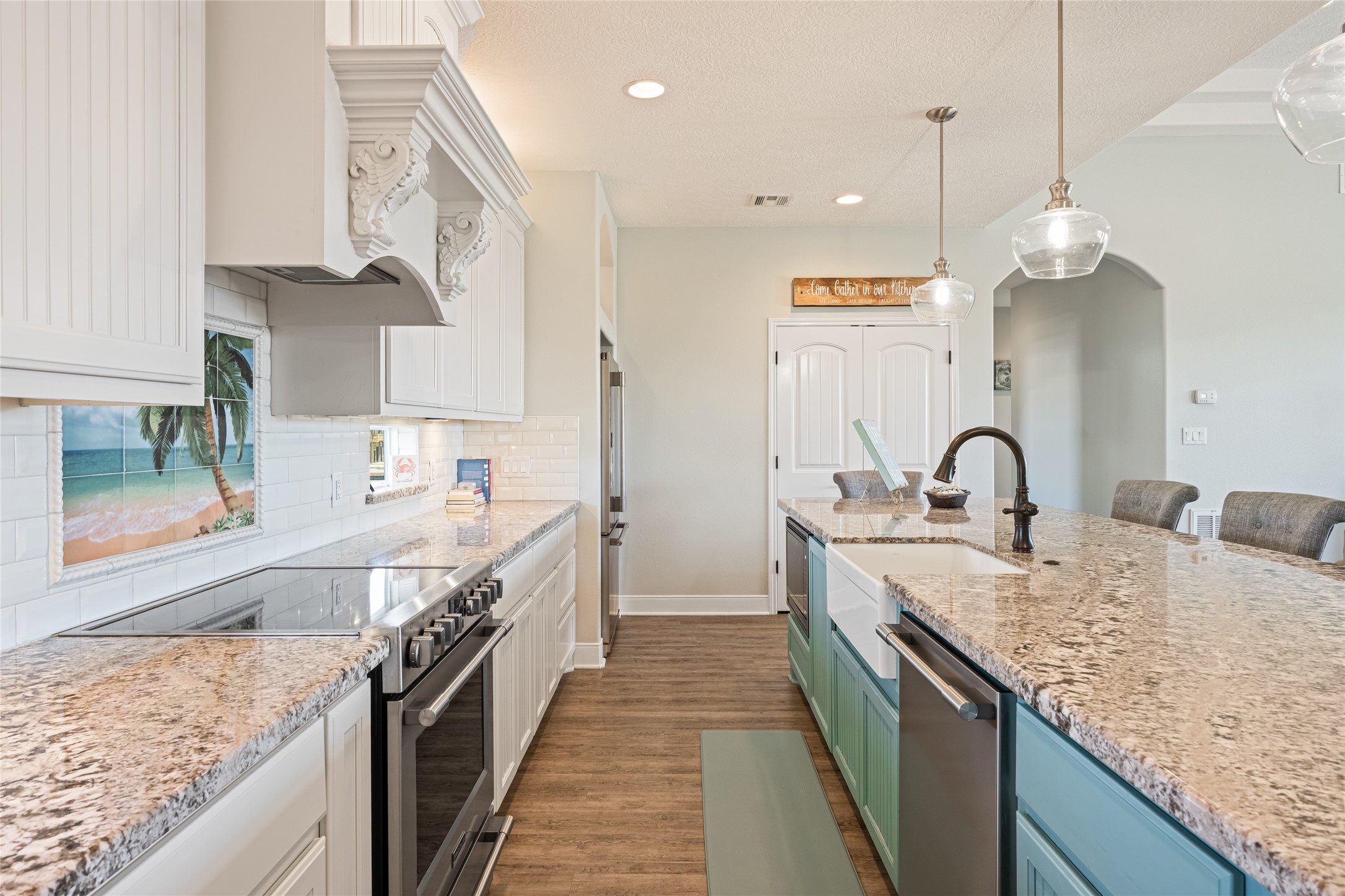 817 Boyt Road Crystal Beach, TX 77650 - Photo 25 of 49 a large kitchen with stainless steel appliances granite countertop a sink a stove and a wooden floors
