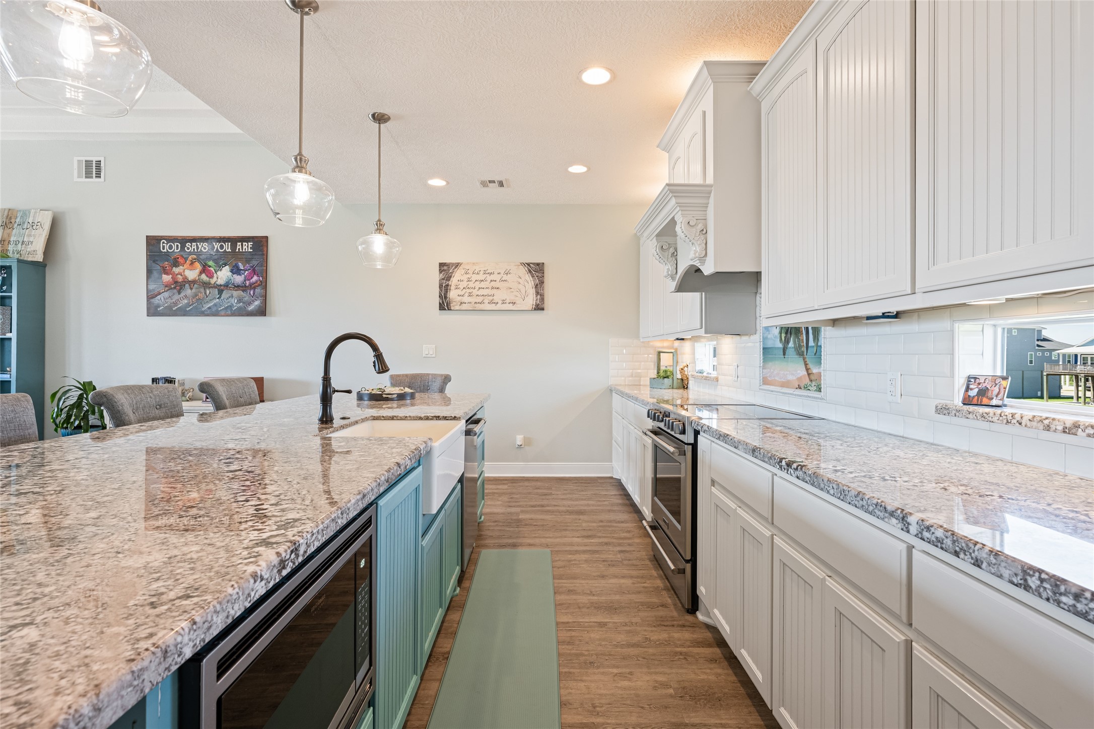 817 Boyt Road Crystal Beach, TX 77650 - Photo 26 of 49 a large kitchen with granite countertop a sink a counter space and stainless steel appliances