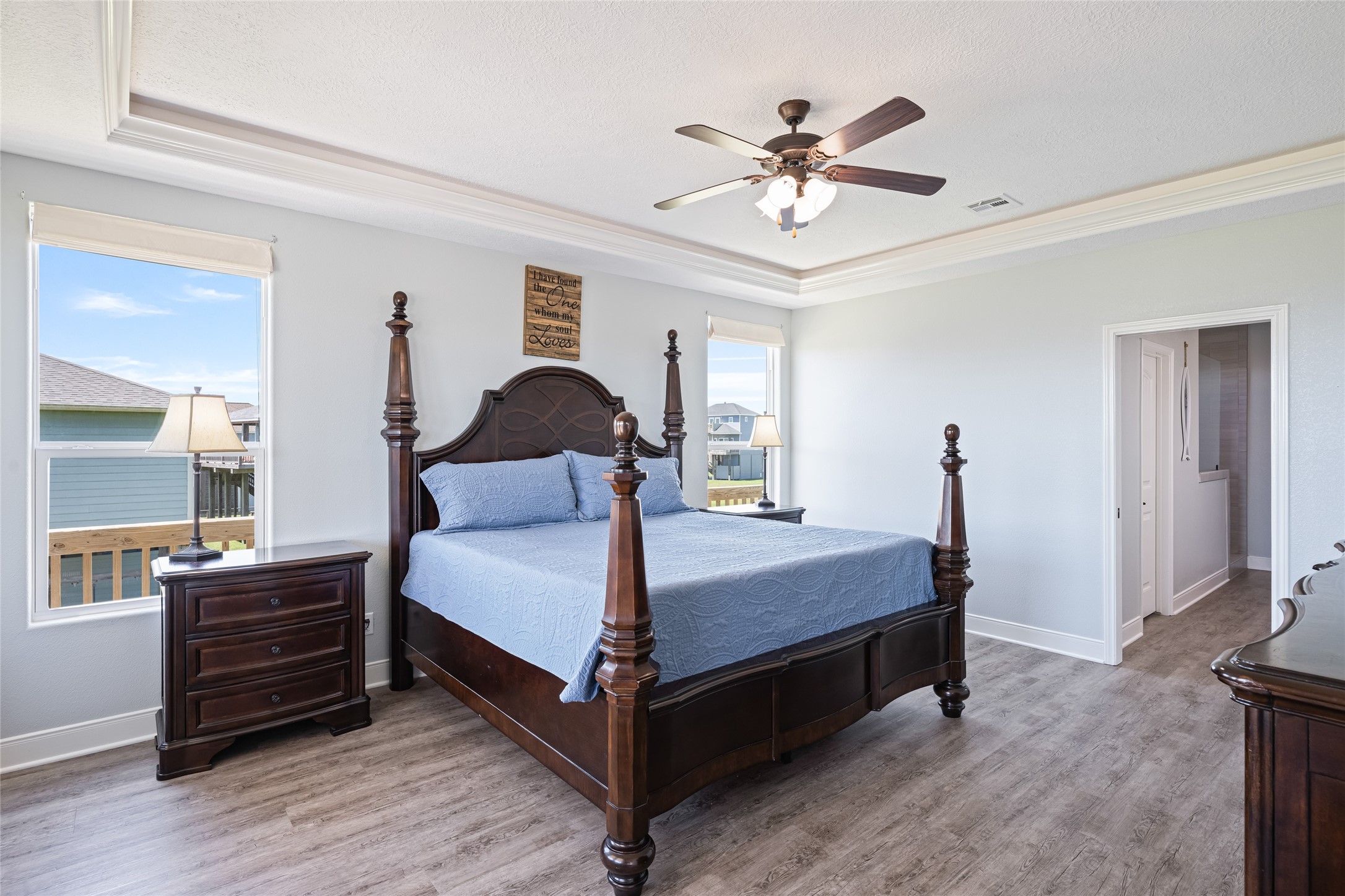 817 Boyt Road Crystal Beach, TX 77650 - Photo 27 of 49 a bedroom with a bed and a chandelier