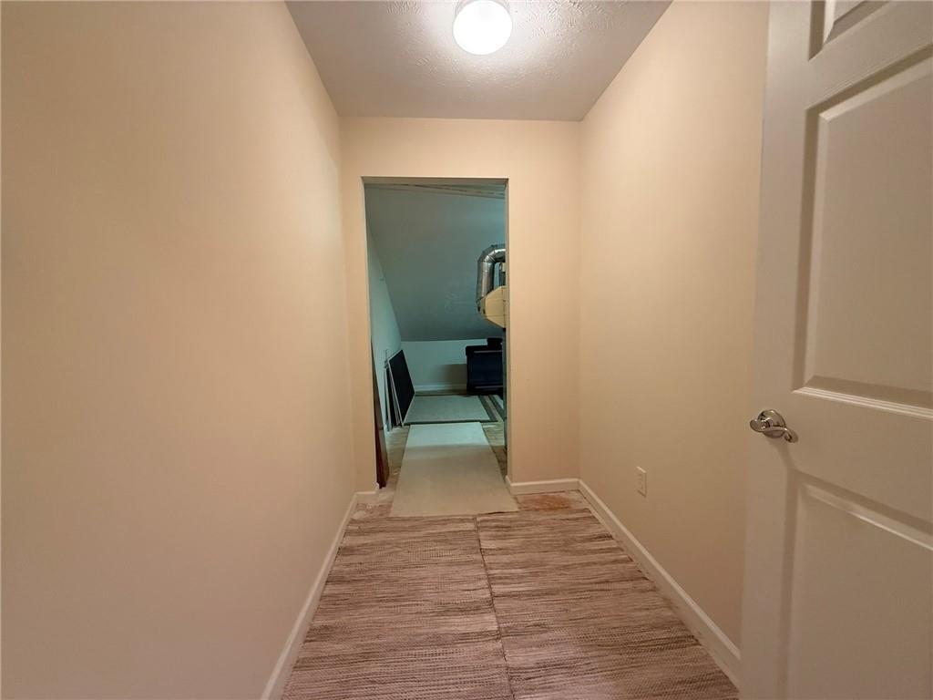 411 Chestnut Lane Apollo, PA 15613 - Photo 24 of 38 a view of a hallway with wooden floor and a bathroom