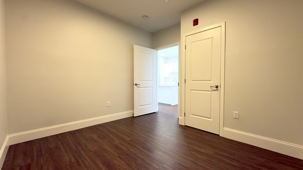205 Maverick Street, Unit 412 Boston, MA 02128 - Photo 13 of 15 an empty room with wooden floor