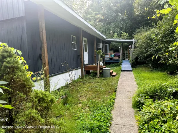 a view of house with backyard outdoor seating and green space
