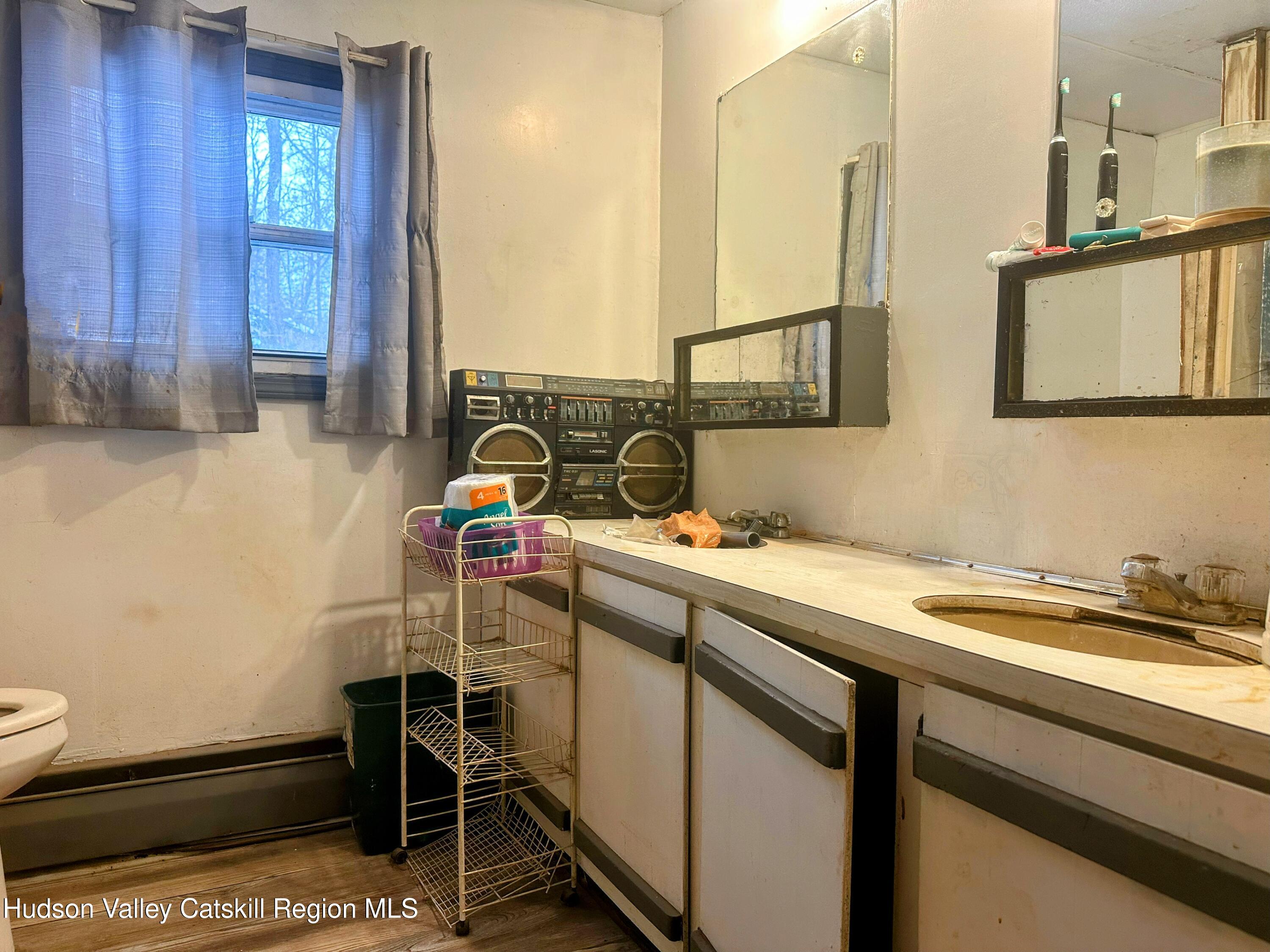 16 Field Road Hudson, NY 12534 - Photo 11 of 24 a bathroom with a sink and a mirror